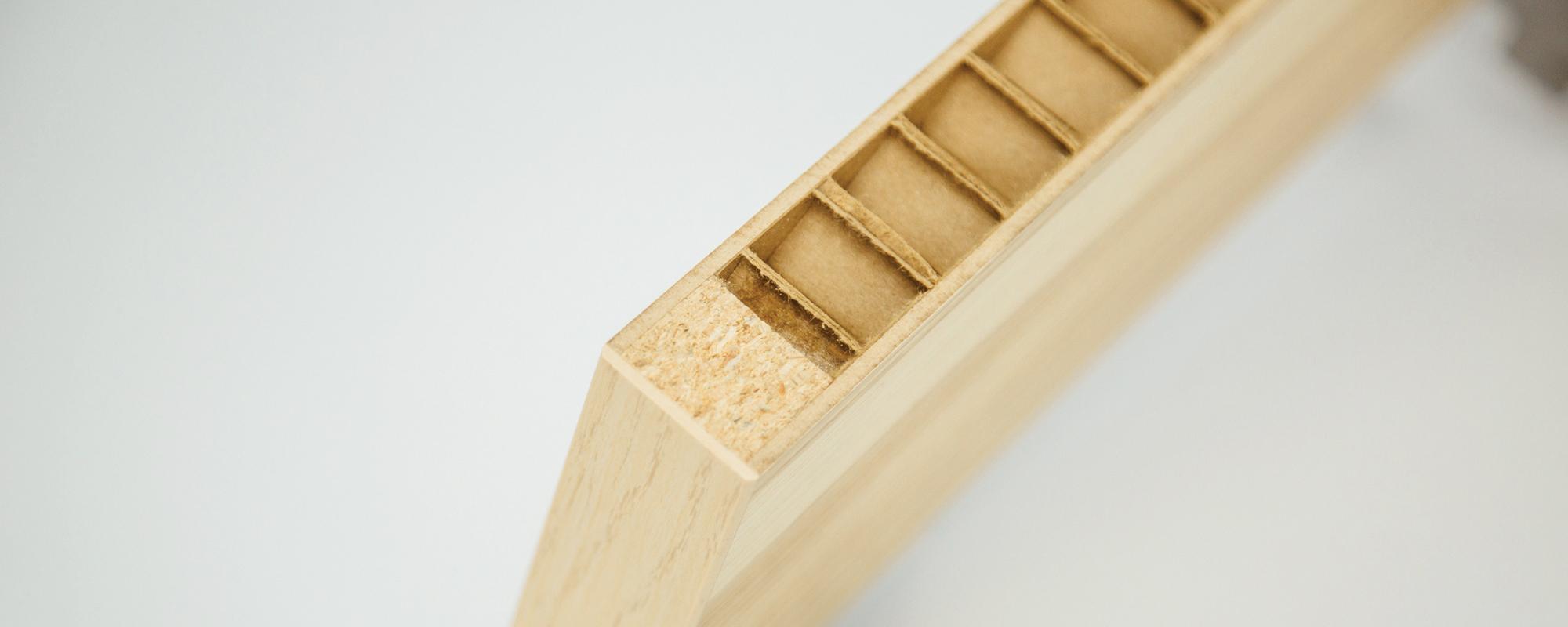 A composite honeycomb panel cut to reveal its core